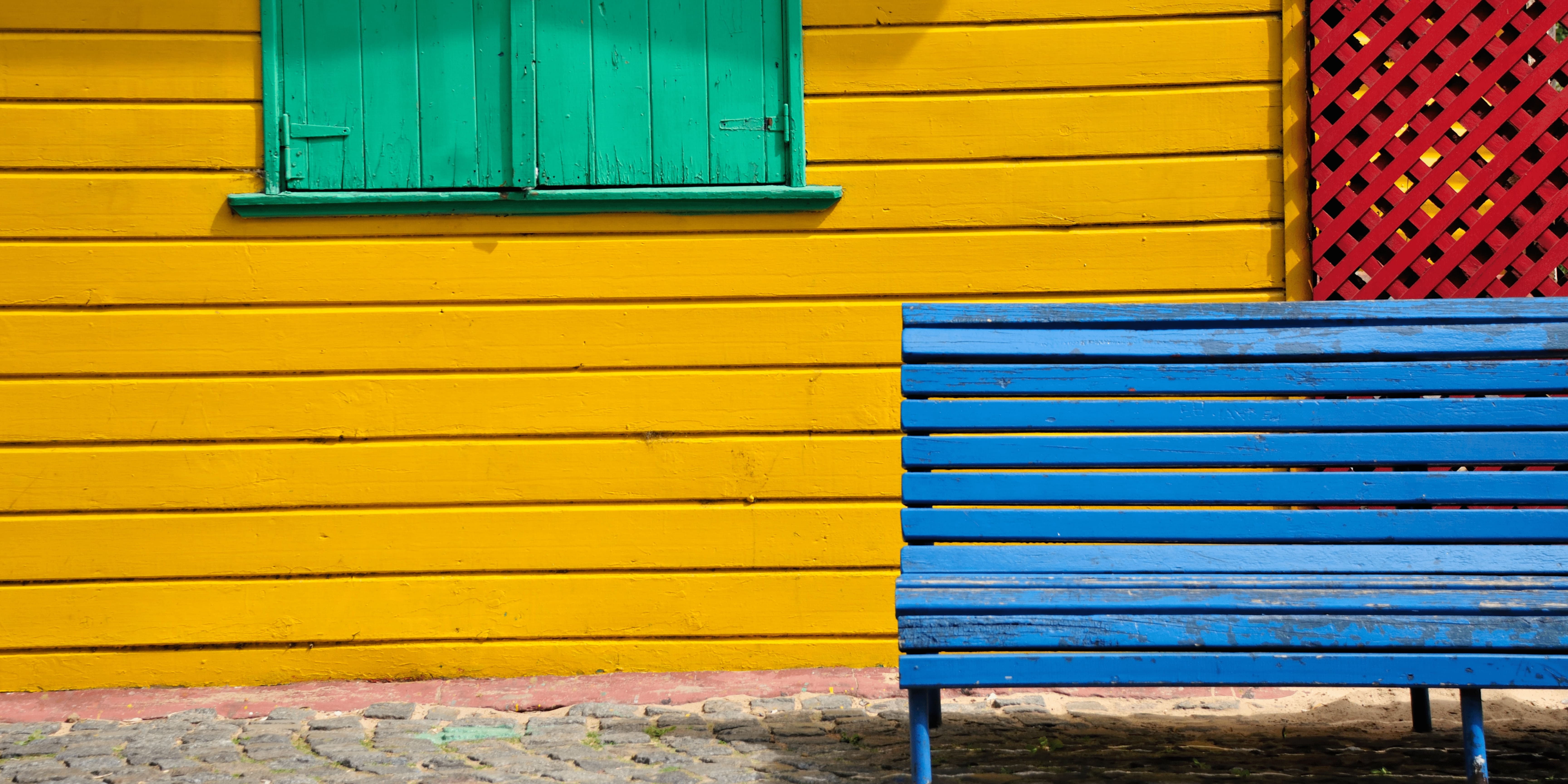 colorful background image of La Boca neighborhood in Buenos Aires.